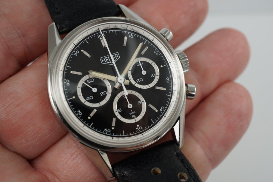 A very nice Heuer Carrera reference CS3113 in stainless steel, crafted circa 1990s. A reissue of the 1964 Carrera model, featuring the black dial with silver applied indexes with lume plots and lume sword-shaped hands, each register encircled by silvered rings. The lugs are beautifully faceted, a great accessory the the sports look.

Original dial, hands and Heuer signed crown.
Case measures 35 x 44mm, 13mm thick.
Lemania cal. 1873, 18 jewels manual winding.
Case# 143xx Movement# 50012xx
Acrylic crystal.
Heuer black rally style strap (80% condition, approximate).
Fits up to 7 1/4inches.
Heuer steel tang buckle.
18mm lug width.
Modeled on 6 inch wrist.
