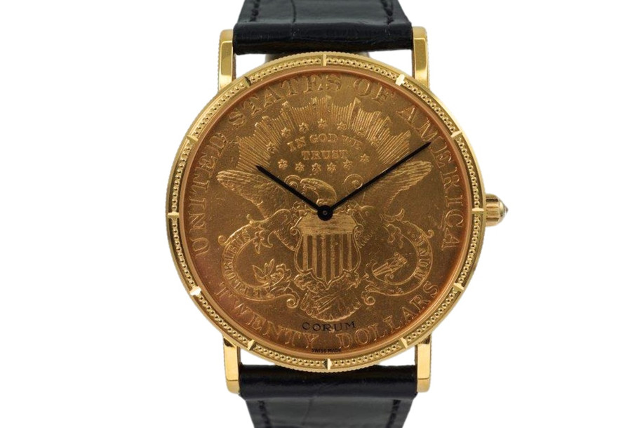 A near mint Corum $20 1900 Liberty US coin watch in 18k yellow gold, crafted during the 1990s. Features classic ridge-edged, beaded minute and notched hour markers on bezel, black-steeled sword-shaped hands and diamond crown. Durable for everyday wear, making a lovely golden statement on the wrist. 

Original dial, hands and diamond crown.
Case measures 35 x 42mm, 4.5mm thick.
High grade Swiss mechanical movement, 18 jewels, 3 adjustments.
Case# 5762xx Movement# 5225xx
Sapphire crystal.
New non-Corum black leather strap.
Fits up to 7 1/5 inches.
Corum 18k tang buckle.
20mm lug width.
Modeled on 6 inch wrist.