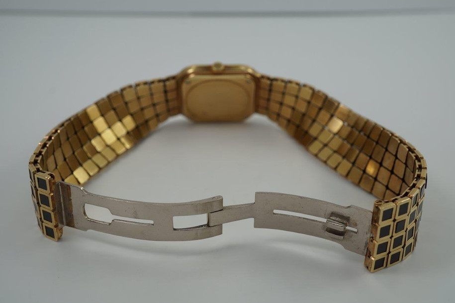 A wonderfully rare Audemars Piguet ladies bracelet watch in 18k yellow gold and black enamel, crafted during the 1980s. A rare and beautiful piece featuring a stylized tile design in the supple bracelet. Gold dial with black leaf hands and minute track, surrounded by black enamel bezel with gold Roman numeral hour markers. The 4-tile motif bracelet is perfectly proportioned for its 22.5mm square case with a deployant clasp providing a seamless look. This slim 5mm silhouette piece wears comfortably and is unseen on the market, making it a beautiful addition for a vintage lover’s collection. 

Enamel bezel contains a crack between 9 and 10 o’clock.
Original dial, hands and crown.
Case measures 22.5 x 24mm, 5mm thick.
Audemars Piguet cal. 2080, 20 jewels mechanical winding.
Case# C177xx Movement# 2822xx
Sapphire crystal.
Audemars Piguet 18k and enamel bracelet, fits 6 1/2 inches or 16.5 cm. 
16mm bracelet width.
Modeled on 6 inch wrist.