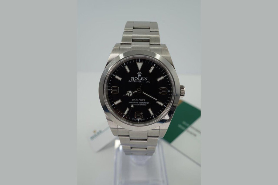 A preowned Rolex Explorer I reference 214270 in stainless steel, crafted in 2016. The 39 mm case features a glossy black dial, luminova baton and arrow hour markers, silver Arabic numerals located 3, 6 and 9 o’clock, luminova Mercedes and sword-shaped hands, and outer white minute track. Houses an automatic movement, steel Oyster bracelet with deployment buckle, and is accompanied by its card dated 5-26-2016 and tag. A handsome accessory for all casual occasions.