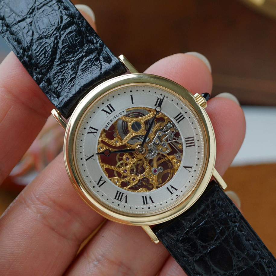 Fabsuisse watch
Fabsuisse vintage
Breguet classique
Breguet skeleton
Breguet sleletonized
Breguet 3020BA
Breguet rare watch
Skeleton watch 18k
Breguet vintage
Breguet vintage 18k
Breguet vintage gold
Breguet gold skeleton
Breguet skeleton vintage
Breguet skeletonized watch
Original dial, hands and crown.
Case measures 33.4 x 38mm, 5mm thick.
Breguet cal. 503SQ manual wind, 18 jewels gold skeletonized hand engraved movement. 
Case# 36xx
Exhibition case back. 
Sapphire crystal.
Breguet black textured leather strap (90% condition, approximation).
Fits up to 7 1/8 inches.
Breguet 18k tang buckle.
19mm lug width.
Modeled on 6 inch wrist.