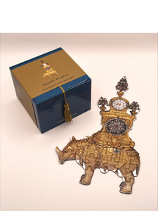 Puzzle box and rhino puzzle assembled and displayed beside the box.