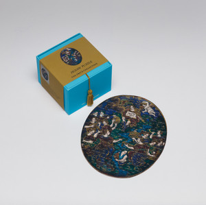 Puzzle box and assembled puzzle of Apollo and the muses displayed beside it.