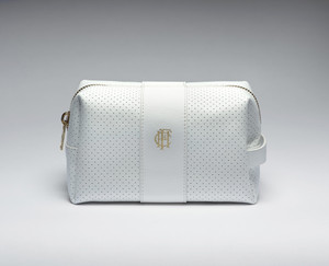 Small white leather bag for cosmetics, sport accessories, and everyday essentials. The bag features the Frick's monogram "HCF" stamped in gold at the center and a gold statement zipper.