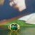 Gold ring featuring a green stone (nephrite/jade) in front of a backdrop of Thomas Cromwell's portrait.