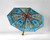 Open umbrella resting on a white surface with a multicolor print on the inside.