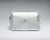 Small white leather bag for cosmetics, sport accessories, and everyday essentials. The bag features the Frick's monogram "HCF" stamped in gold at the center and a gold statement zipper.