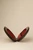 Open walnut wood Moon handbag displaying its red leather lining and hinged construction.