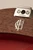 Close-up of the handbag's wood construction and silver-tone hardware, showing the Frick Collection monogram and Eittem maker’s mark.