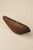 Closed Bird handbag viewed from the side, highlighting its sculptural, streamlined wood form.