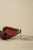 Bird handbag shown open, revealing its red leather interior, silver-tone hardware, and attached chain strap.