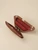 Open Bird handbag with a dark walnut wood exterior, red leather lining, and silver-tone hardware and clasp.