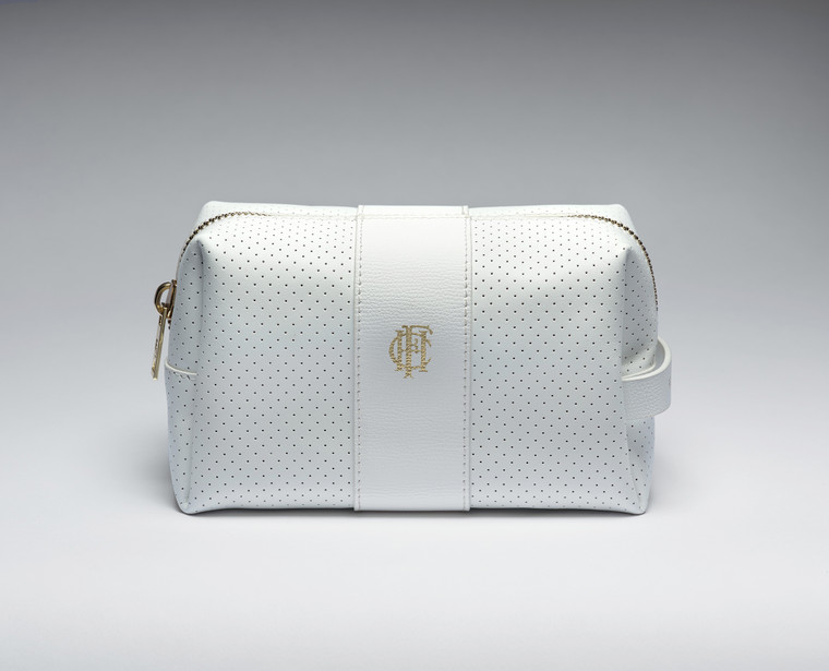 Small white leather bag for cosmetics, sport accessories, and everyday essentials. The bag features the Frick's monogram "HCF" stamped in gold at the center and a gold statement zipper.
