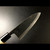 Authentic Tsukiji Aritsugu black Deba knife with a rustic black-forged finish for heavy-duty butchery.