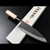 Authentic Tsukiji Aritsugu black Deba knife with a rustic black-forged finish for heavy-duty butchery.