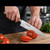 Professional chef slicing a tomato with an authentic Tsukiji Aritsugu Gyuto 195mm Japanese chef knife