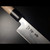 Close-up of authentic Aritsugu Santoku knife 180mm with Japanese blade engraving and traditional wooden handle