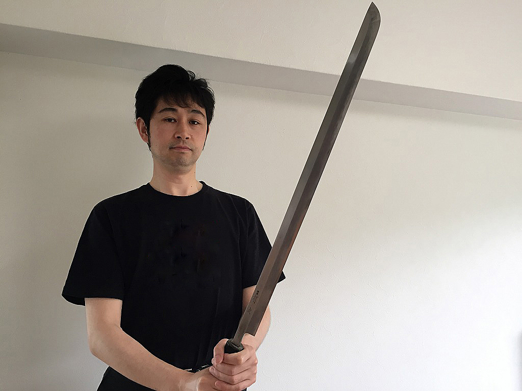 Takao Sakamoto, Director of Japanese-Knives.com, holding an authentic long Aritsugu knife.