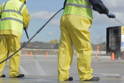 Workers wearing industrial rain gear during emergency response operations