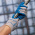 Worker wearing Atlas Fit latex-coated gloves handling tools during maintenance and warehouse work