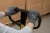 Worker wearing gray HyFlex work gloves while gripping and pushing a pallet jack handle in a warehouse with stacked boxes