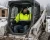 Worker wearing a Class 3 hi-vis fleece-lined safety jacket while operating a Bobcat on a snowy winter worksite