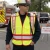 Fire department public safety worker wearing an ANSI Class 2 breakaway FIRE vest at an incident command scene.