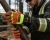 Industrial worker wearing Torq Hail Xtra cut and impact-resistant gloves while gripping a metal pipe