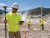 Worker wearing a hi-vis safety T-shirt with 35 UPF sun protection while performing geothermal surveying outdoors