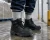 Worker wearing thermal socks with black insulated work boots on an icy floor in a cold storage warehouse