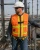 Worker wearing a hi-vis orange safety vest with integrated fall protection harness