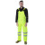 Construction worker wearing ANSI Class E high-visibility rain bibs in wet conditions