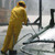Worker wearing Hydroblast rain suit in heavy rain on jobsite
