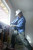 Worker wearing cowboy style full brim hard hat safety helmet on construction site providing ANSI certified head protection
