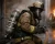 Firefighter wearing MSA SCBA breathing apparatus, face mask, helmet, gloves, and turnout gear while operating a hose during structural fire response