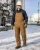 Industrial worker wearing insulated FR duck bib overalls with hard hat, safety glasses, and gloves at a snowy utility jobsite