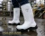 Worker wearing 15-inch white composite toe PU safety boots on a wet industrial jobsite