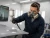 Worker wearing 3M 6001 organic vapor cartridges while spray painting in a controlled paint booth