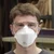 Worker wearing 3M Aura 9210 Plus N95 respirator in industrial environment