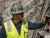 Worker wearing an MSA V-Gard camouflage full brim hard hat at an outdoor industrial worksite