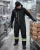 Worker wearing -60°F softshell extreme freezer bib overalls while handling packaged ice cream in a cold food processing plant