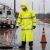 Worker wearing an FR high-visibility rain coat during roadside utility maintenance in wet weather