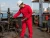 Vessel Crewman Wearing Red Coverall For Maintenance Work