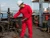 Vessel Crewman Wearing Red Coverall For Maintenance Work