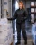 Female cold storage worker wearing a black insulated freezer jacket while checking frozen product boxes at a refrigerated loading dock.
