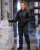 Female cold storage worker wearing a black insulated freezer jacket while checking frozen product boxes at a refrigerated loading dock.