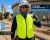 Construction worker wearing a cooling evaporative vest with a bandana and neck gaiter on a hot outdoor jobsite