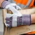 Worker wearing leather palm work gloves while gripping wooden crate on jobsite