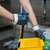 Warehouse worker wearing nitrile coated gloves handling oily metal parts