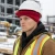 Construction worker wearing a hard hat winter liner under a hard hat at a cold weather jobsite